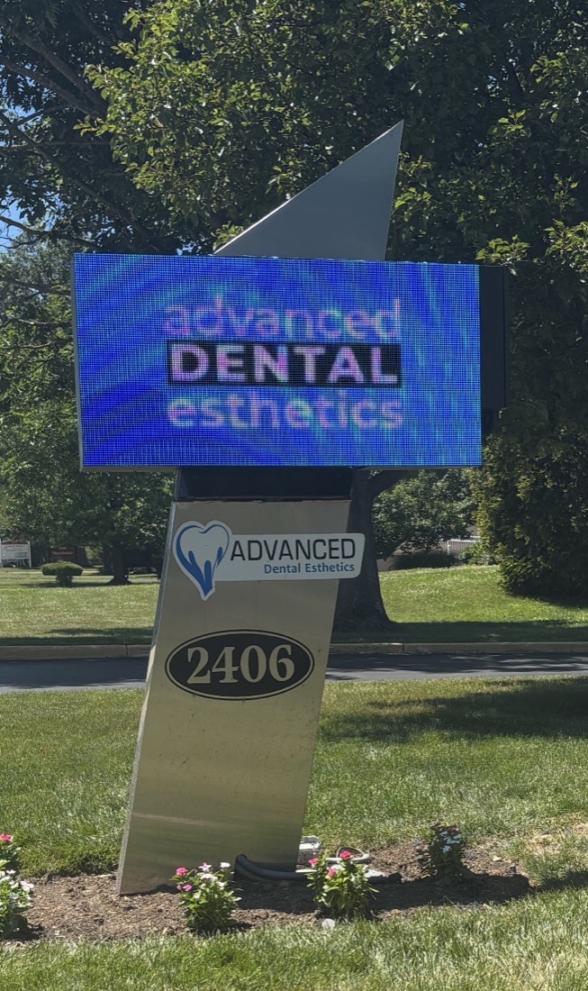 Advanced Dental Esthetics pylon sign with full-color LED digital display